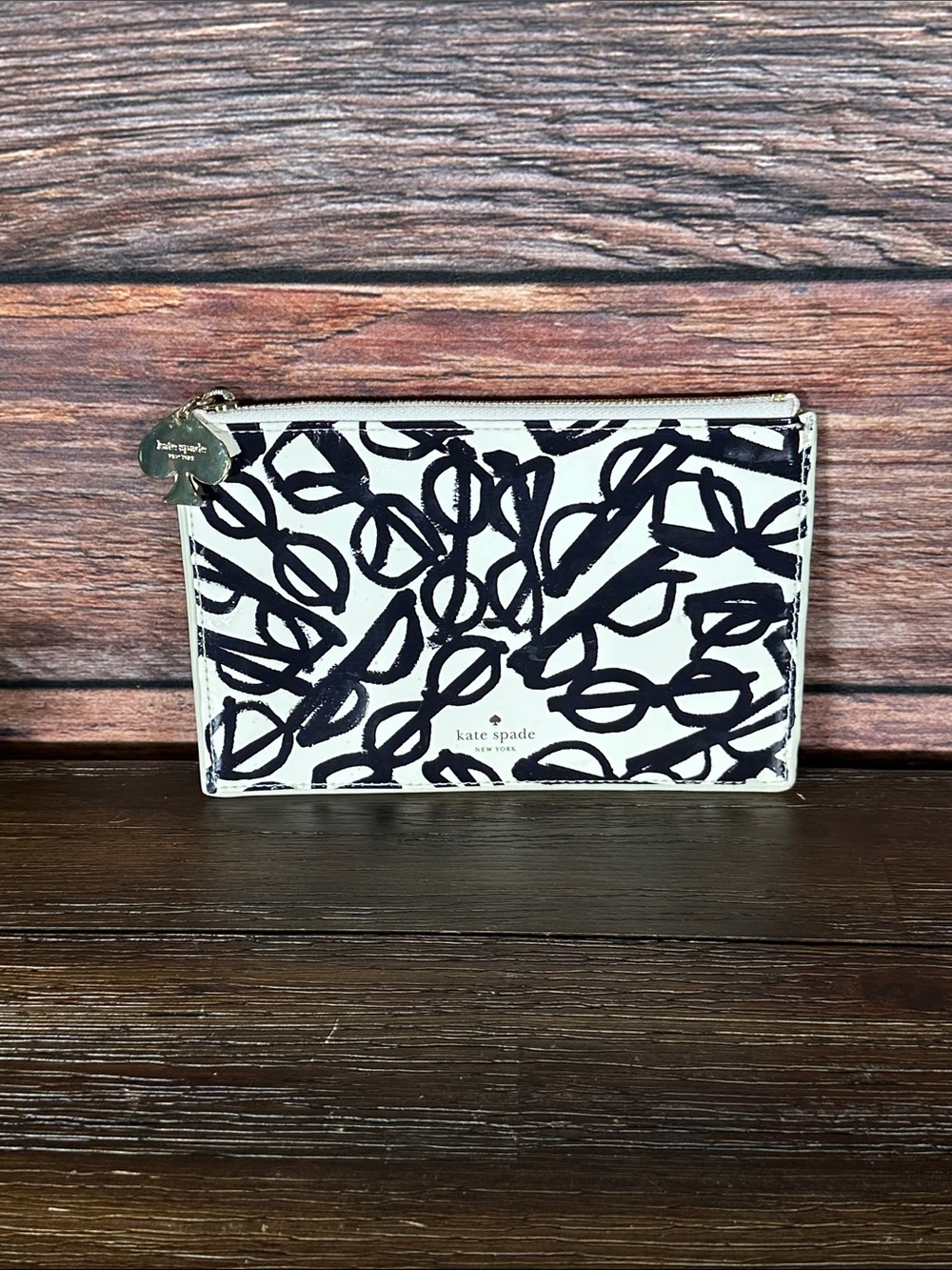 Kate Spade New York pouch features a whimsical "literary glasses" print